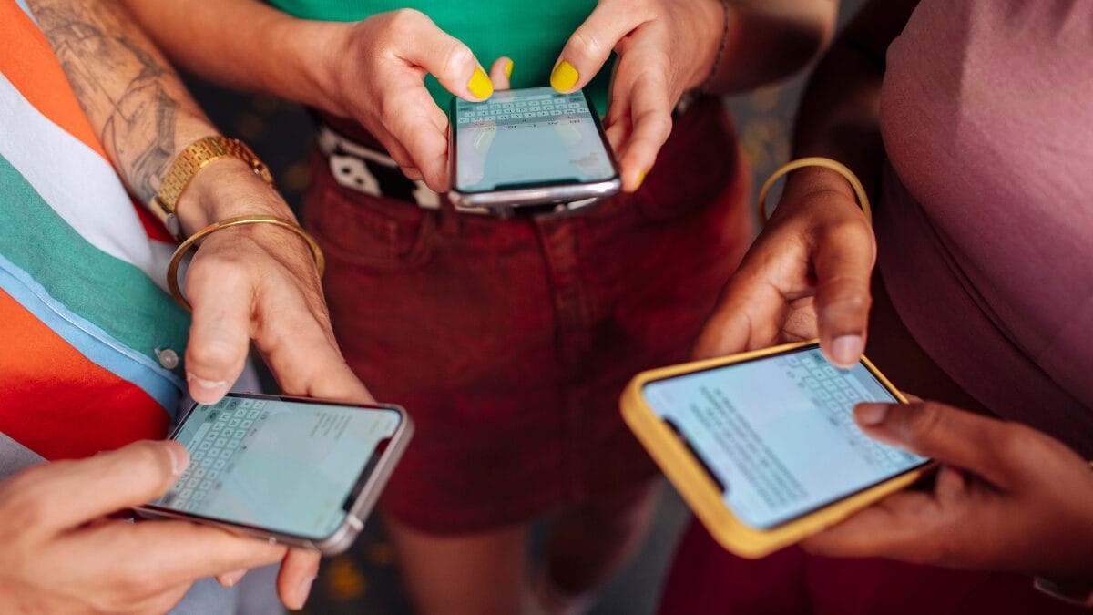 Hands typing on smart phones stock photo
