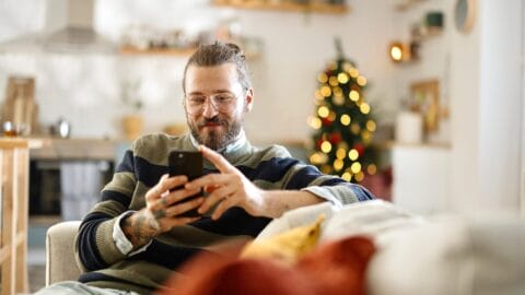 Shopper scrolling on phone during the holiday season
