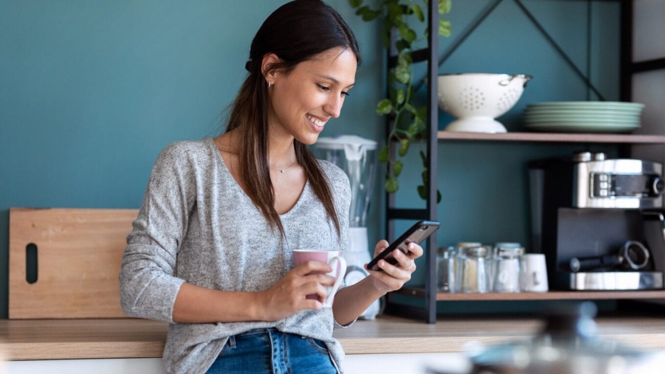 Female consumer smile at brand she likes on phone