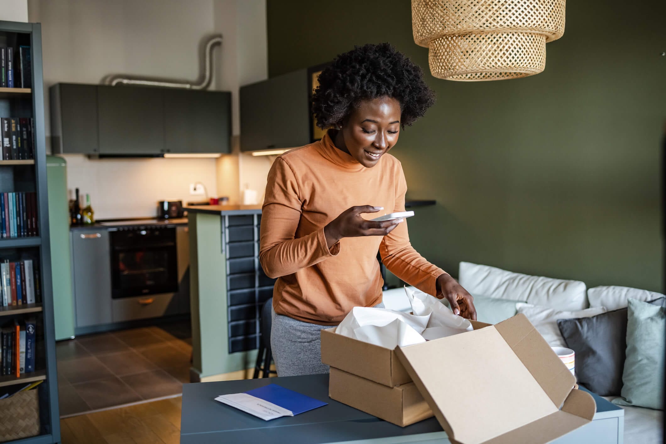 Young woman taking a photo of a subscription box stock photo