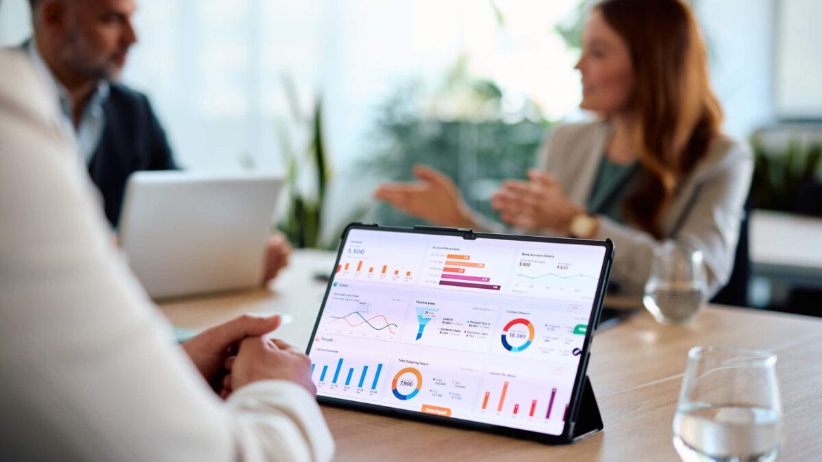Businessman using tablet to look at loyalty marketing metrics